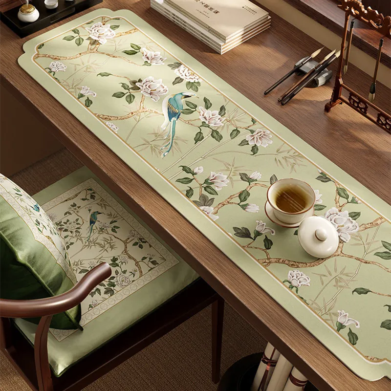 Angled view of Style B tea mat leather placemat with teacup and tea tray on top.
