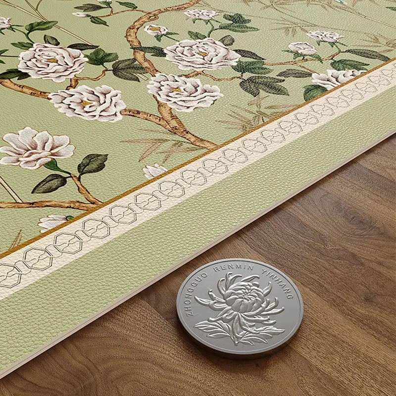 Thickness detail of chinoiserie jade green leather round table mat shown next to a coin.