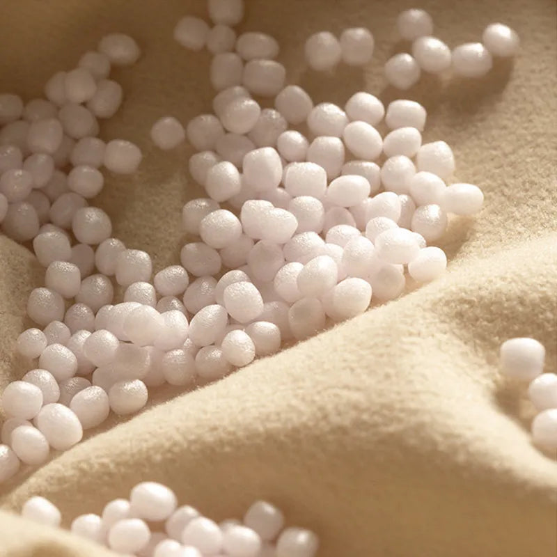 Close-up of the couch cushion pouf filling showing eco-friendly foam beads with a large, cushioned texture.
