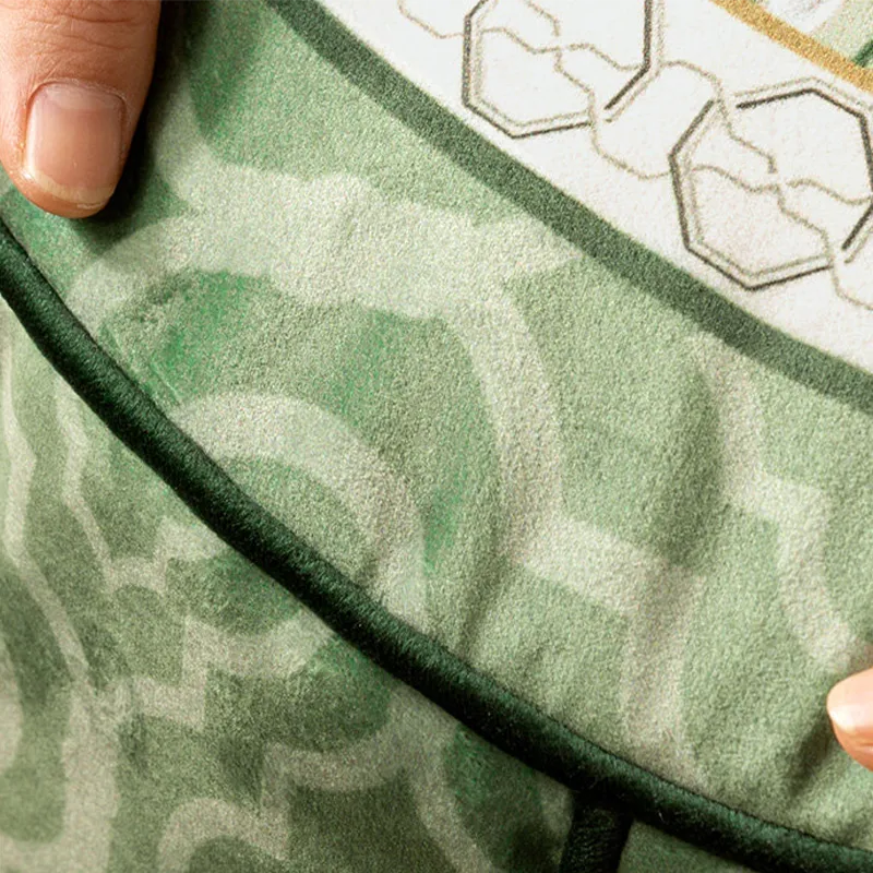 Close-up of the couch cushion pouf cover showing neat piping trim and fine stitching details.