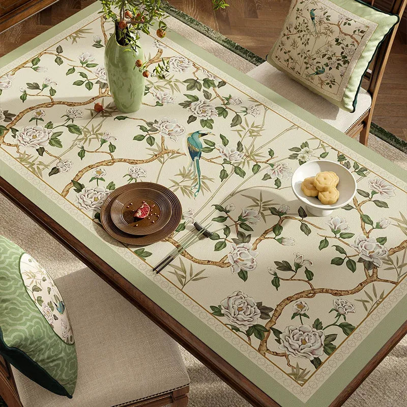 Style A chinoiserie jade green rectangular leather table mat on dining table, angled view.
