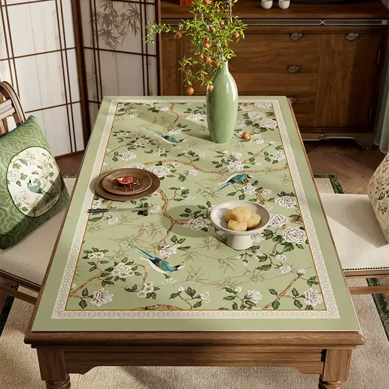 Style B jade green chinoiserie rectangular leather table mat laid flat on dining table, top view.
