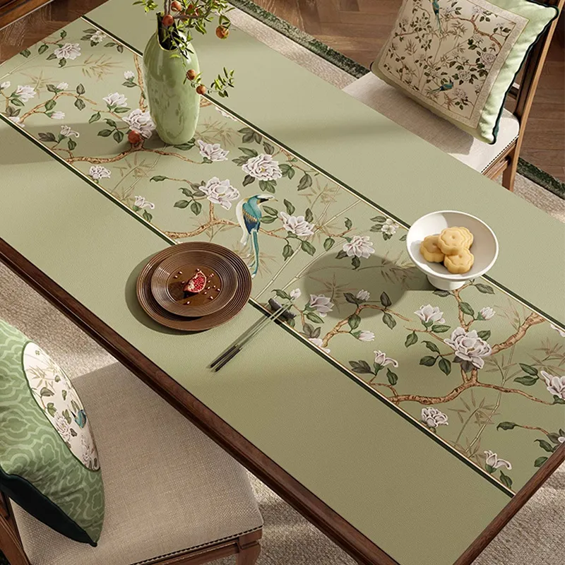 Style C chinoiserie jade green rectangular leather table mat on dining table, angled view.