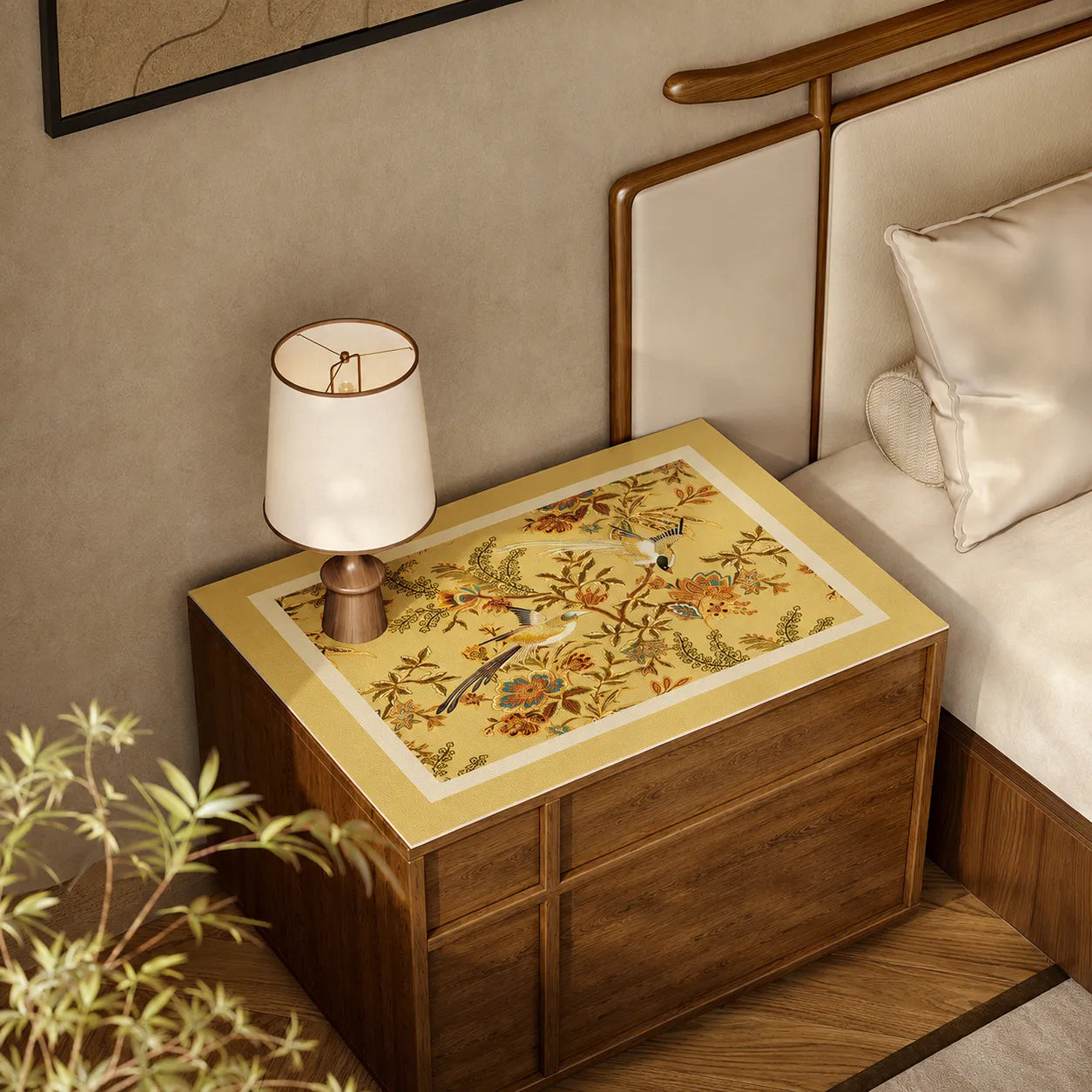 Autumn Splendor leather nightstand top protector mat with golden Chinoiserie floral and bird design on a wooden bedside table.