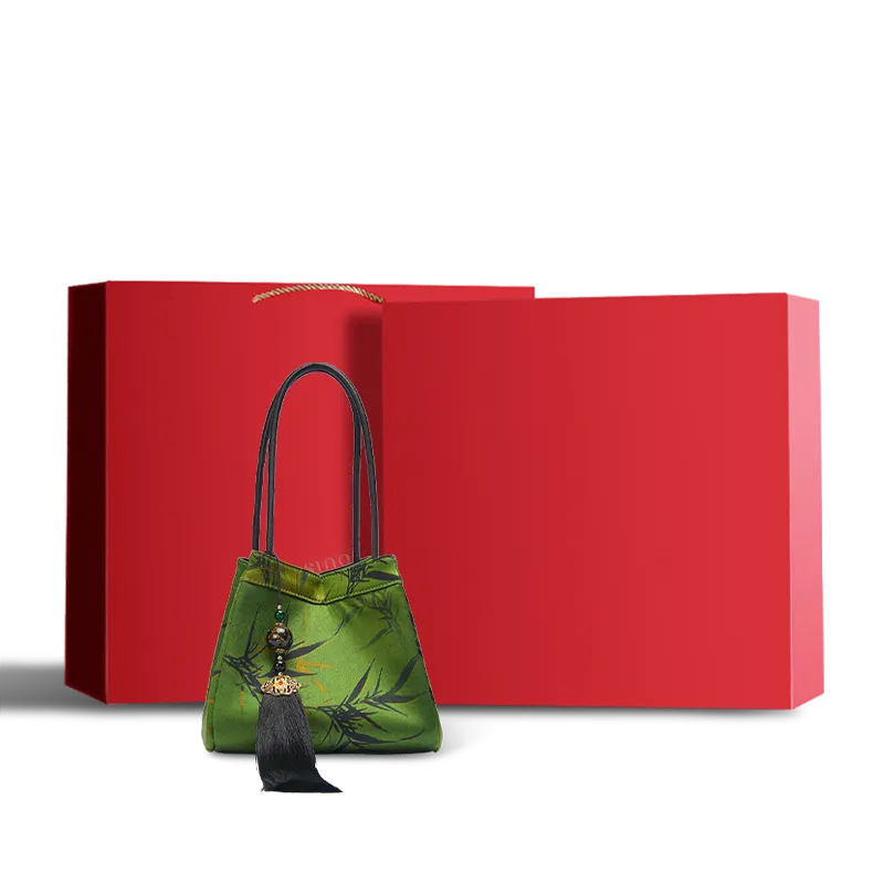 Dark green Xiangyunsha silk jacquard bucket bag presented in a red gift box.