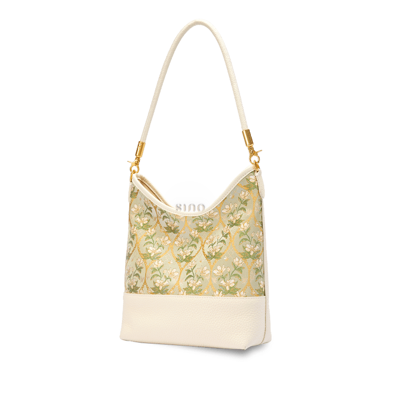 Angled view of the Dayun Brocade Verdant Floral leather shoulder bag in a refined Chinoiserie style.