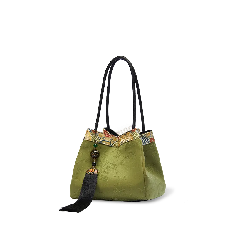 Side view of the light green Xiangyunsha silk jacquard bucket handbag on white background.