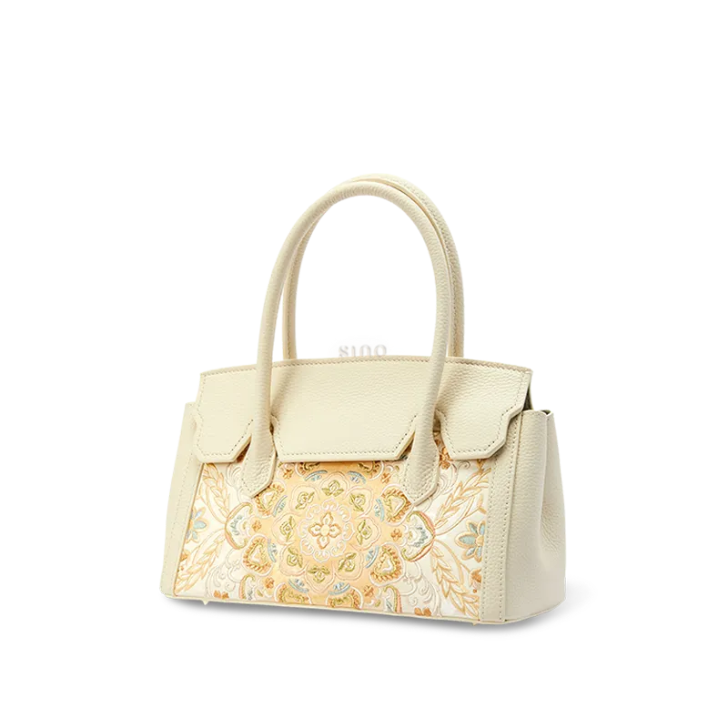 Side view of chinoiserie luxury lotus motif leather handbag.