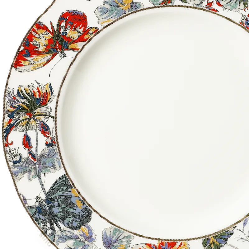 Close-up: Left rim butterfly/floral detail and clean center on bone china plate.