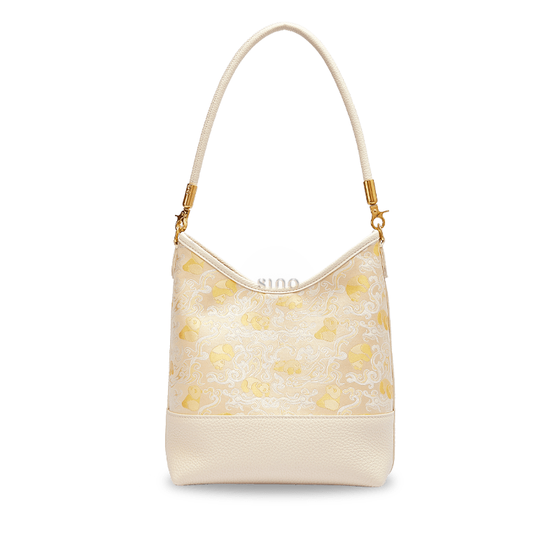Front view of the Chinoiserie Luxury Shu Brocade Panda and Dragon Leather Shoulder Bag with elegant ivory leather and brocade pattern.