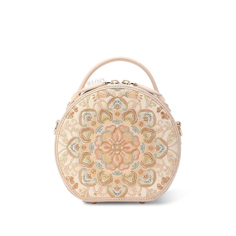 Vintage round leather bag with silk-embroidered Chinoiserie floral motif.