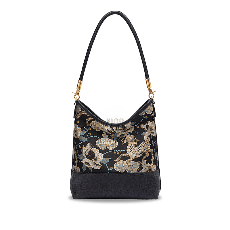 Front view of the black and gold Qilin Peony Song Brocade leather shoulder bag.