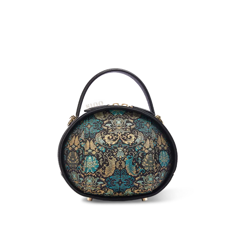 Front view of black Song Brocade handbag with Plantain Leaf Pattern on white background.