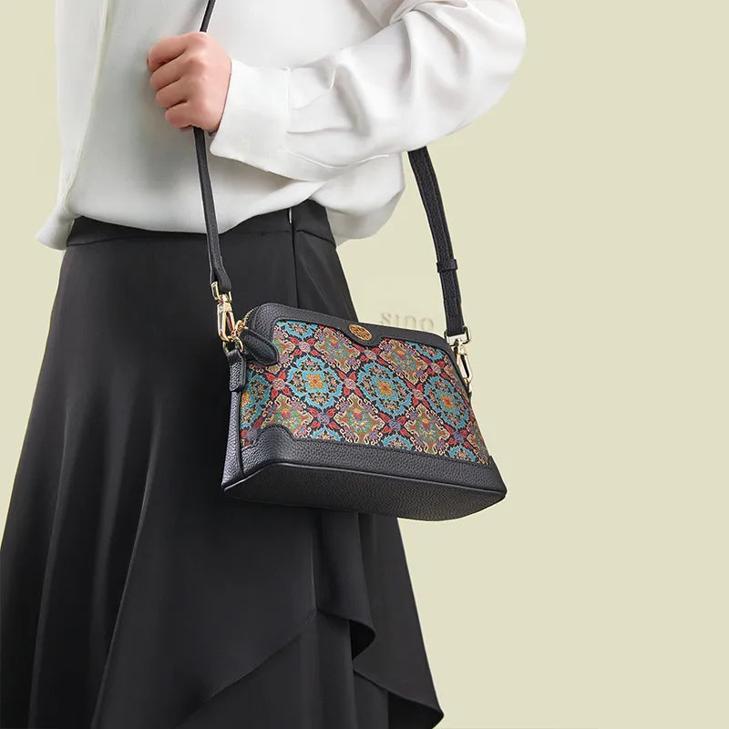 Model standing sideways wearing the Curled Lotus clutch bag as a shoulder bag.