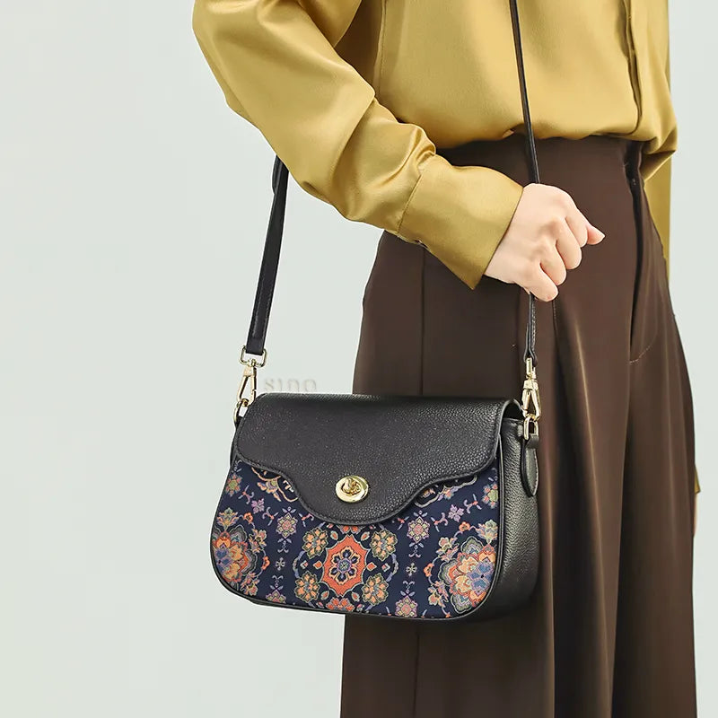 Shoulder carry at waist with hand on strap, luxury Chinoiserie bag.