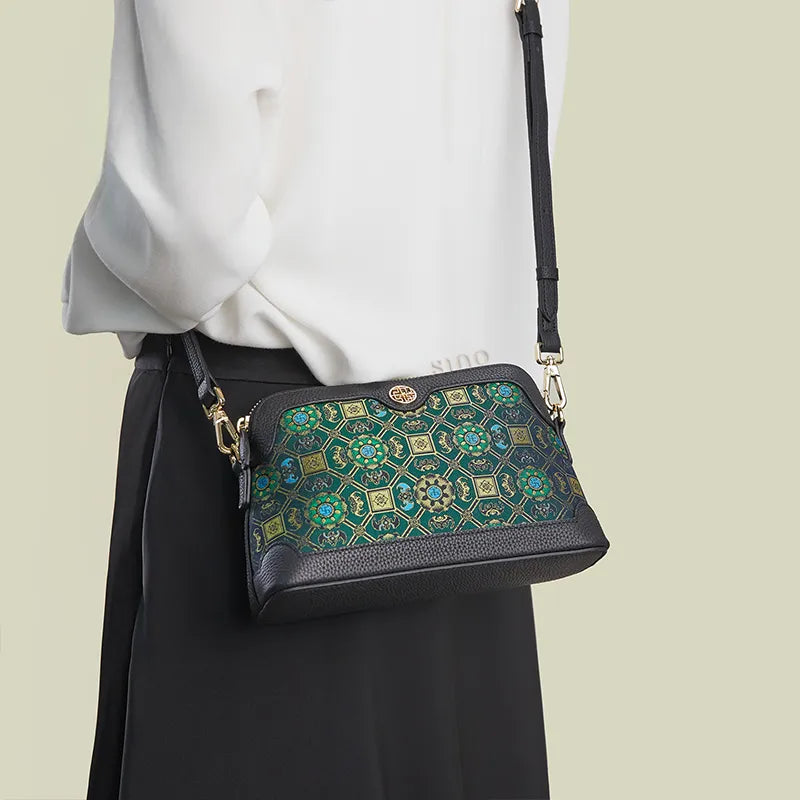 Model back view wearing the Lotus & Bat Motif crossbody clutch bag with strap.