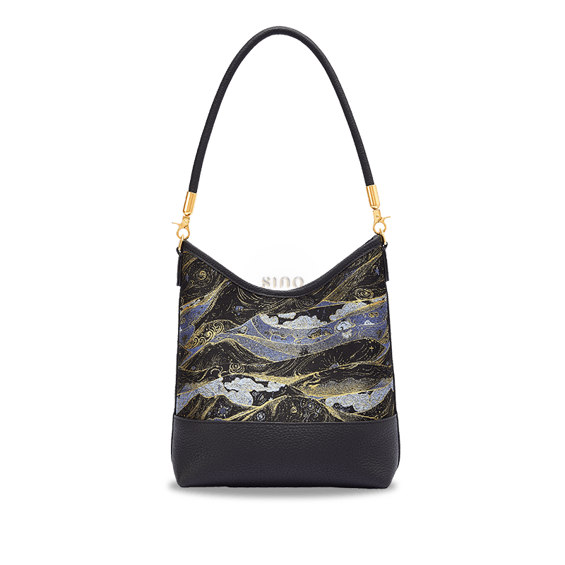 Front view of the Moonlit Splendor Song Brocade leather shoulder bag with blue, gold, and black woven details.