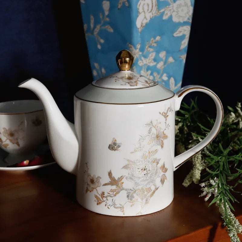 Chinoiserie Coffee Pot with round Bone China cups backdrop.