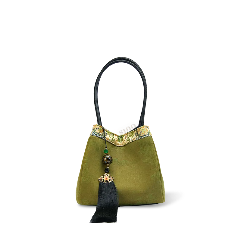 Front view of green bucket bag in Chinoiserie style with Xiangyunsha silk and leather.
