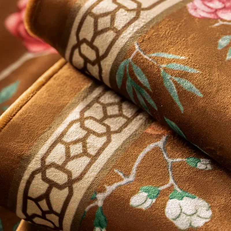 Soft embroidered fabric close-up of chinoiserie magpie pillow.