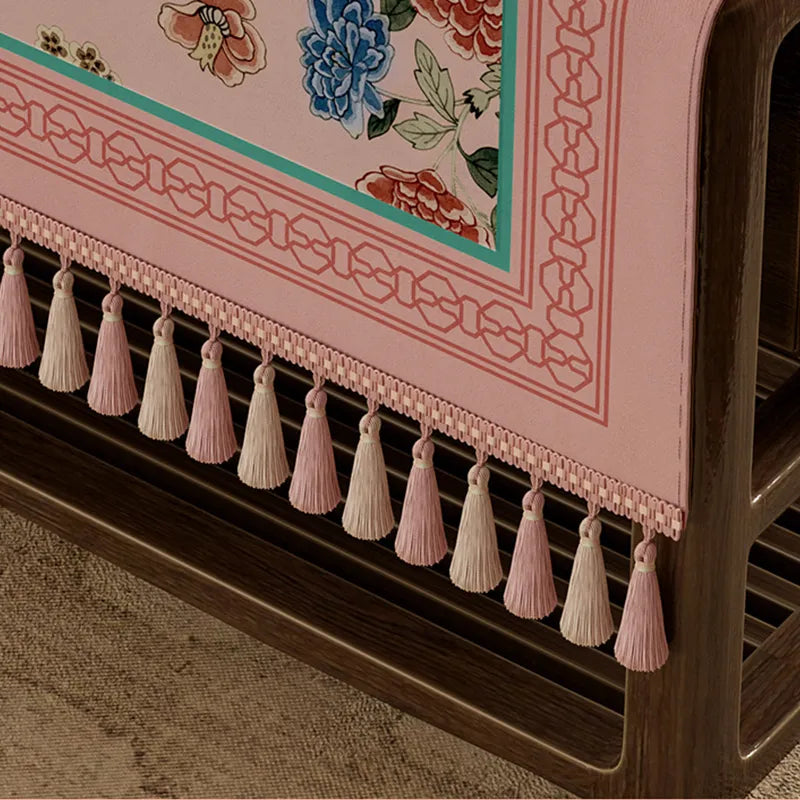 Artisanal hand-tied fringe on tablecloth edge.