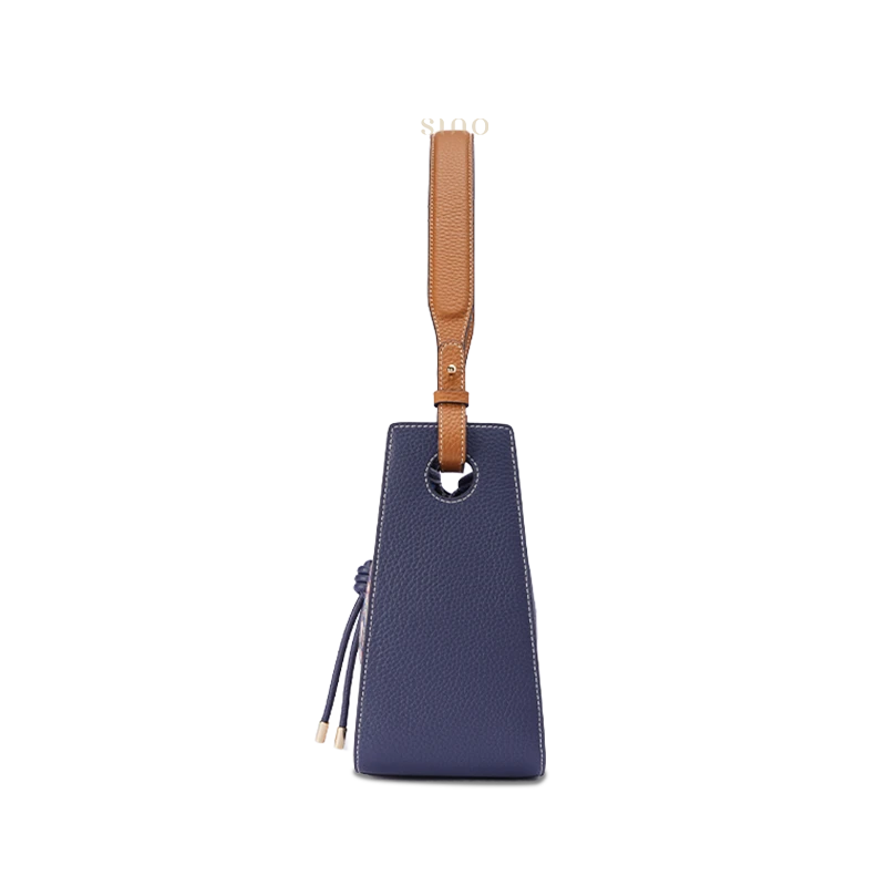 Guardian Blessing large leather shoulder bag side view with structured silhouette and shoulder strap.