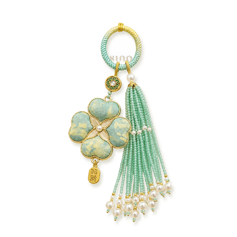 Green Chinoiserie Song Brocade auspicious four-leaf clover tassel bag charm with pearl tassels, gold-tone trim, and a lucky pendant.