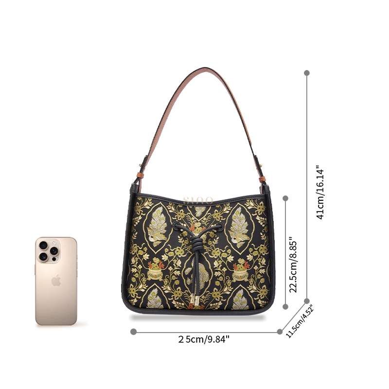 Peacock Prosperity large shoulder bag size reference shown beside a smartphone for scale.