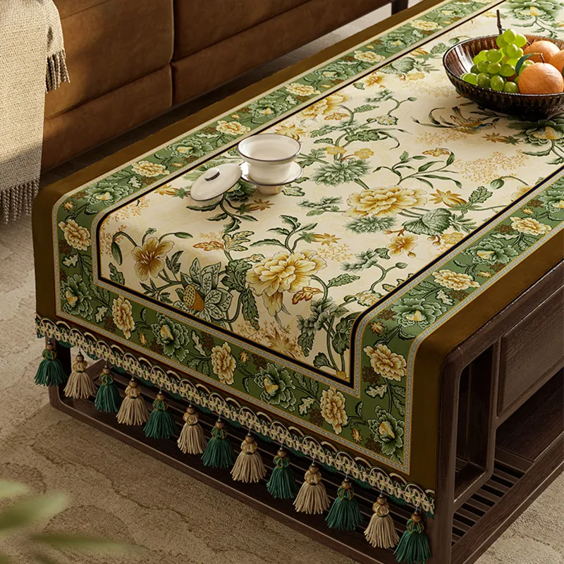 Decorative fringe trim on vintage green tablecloth.