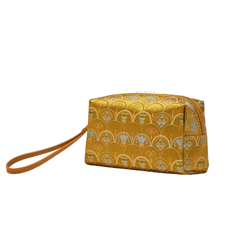 Brown vintage brocade clutch wallet, side view showing the compact shape and wristlet design.