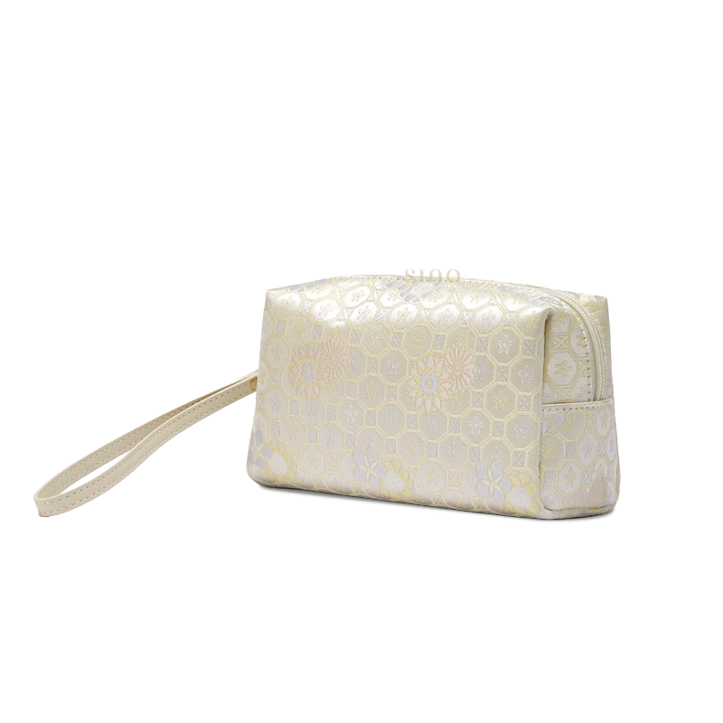 Ivory brocade wristlet clutch wallet for women, side view with compact silhouette and woven Chinese-inspired pattern.