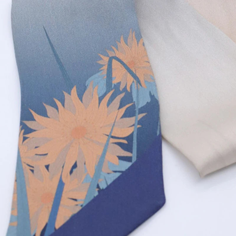 Close-up of the Cloud & Water mulberry silk twilly tip, highlighting the blue gradient and delicate printed motif.