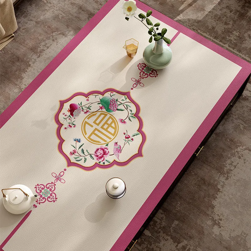 Coral pink leather coffee table mat with center Chinoiserie pattern.