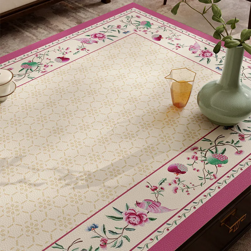 Coral pink leather coffee table mat with floral pattern detail.