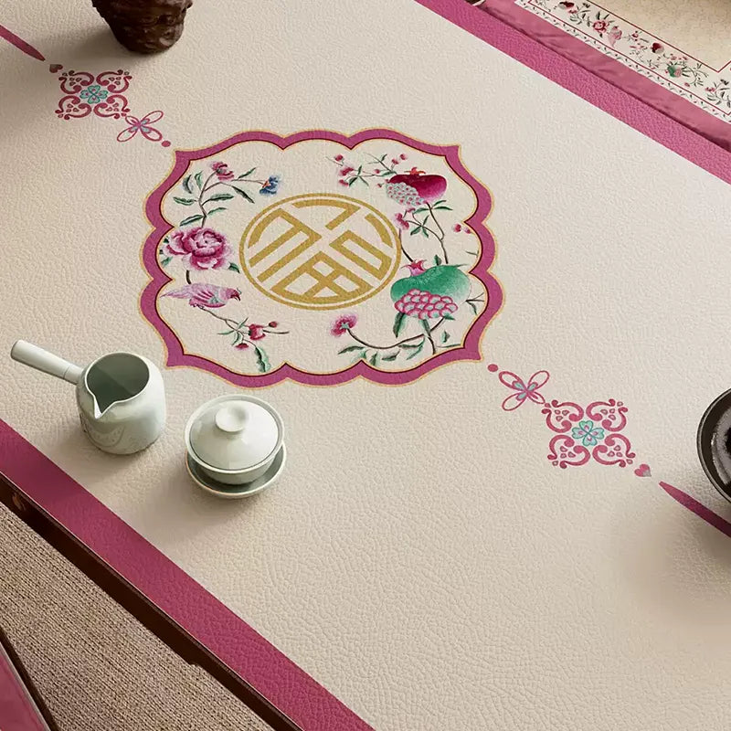 Coral pink leather table mat with longevity motif detail.