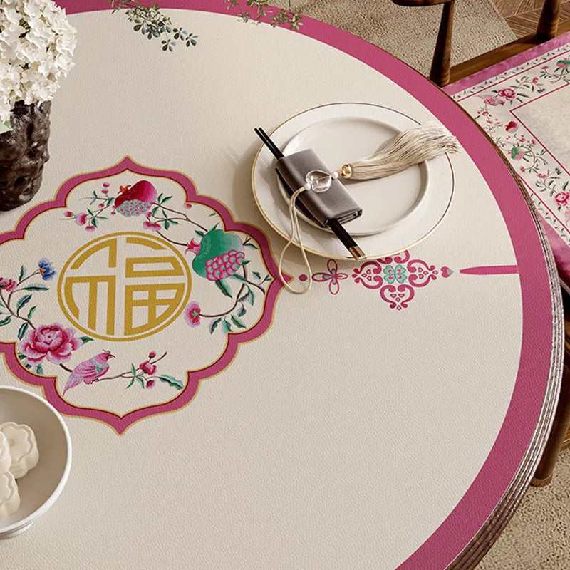 Coral pink round leather table mat with longevity motif detail.