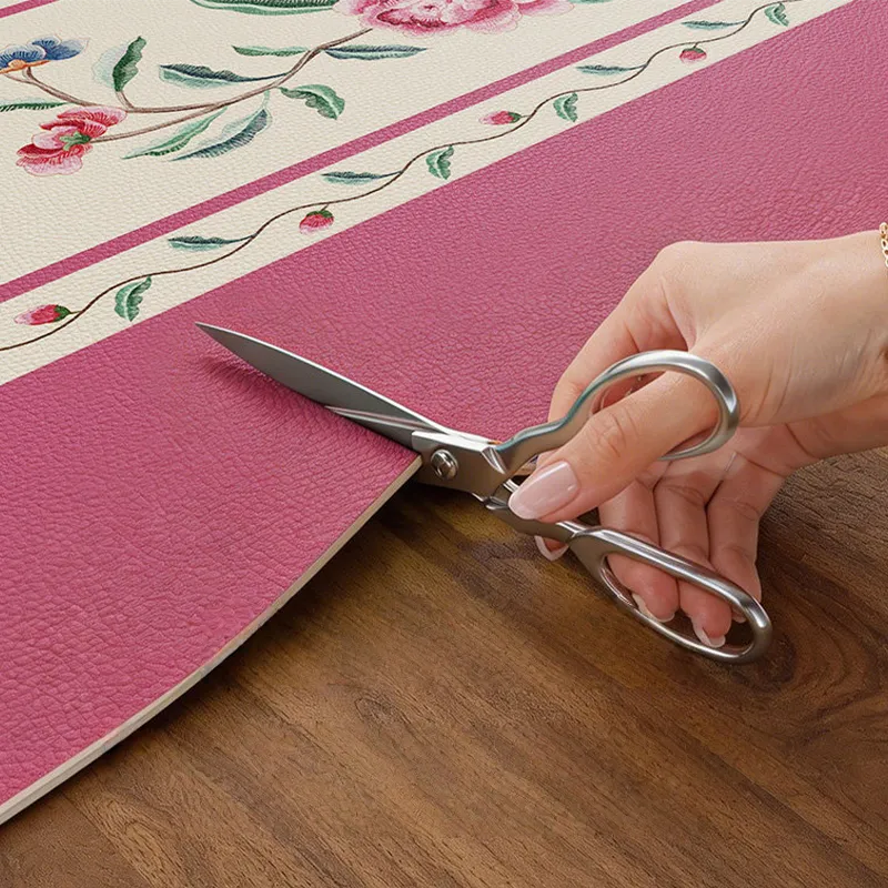 Custom cut coral pink round leather table mat.