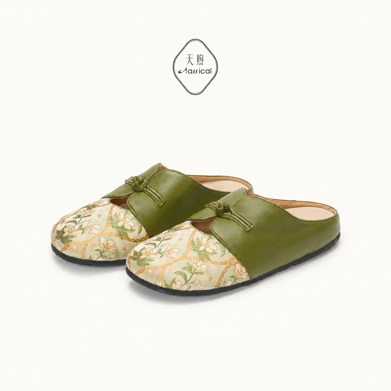Pair of women's green Dayun Brocade floral mules with elegant knotted leather detailing.