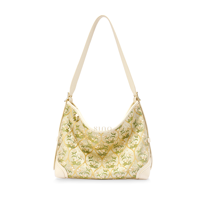 Front view of Chinoiserie Luxury Dayun Brocade Verdant Floral Leather Crossbody Bag, showcasing green floral pattern and leather details.