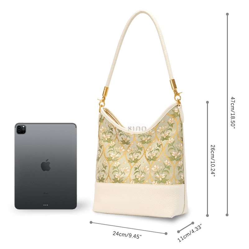 Size and capacity comparison of the Chinoiserie Luxury Dayun Brocade Verdant Floral Leather Shoulder Bag shown beside a tablet.