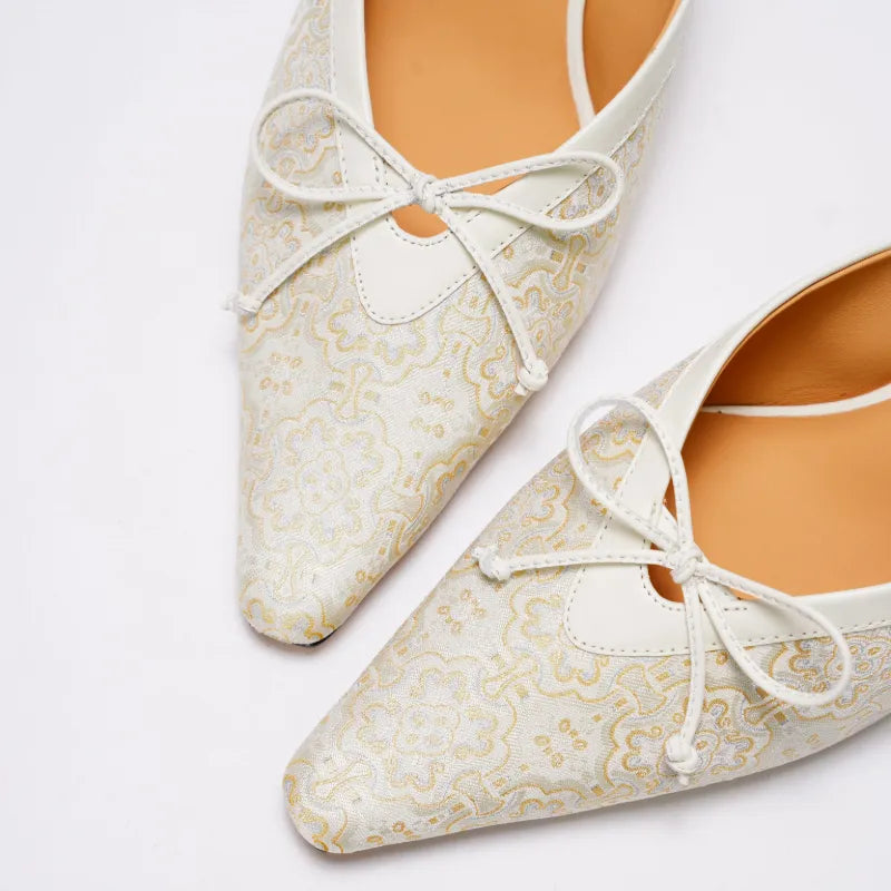 Close-up of Ding Sheng pattern Song Brocade shoes showcasing auspicious Chinese motifs and fine weaving details.