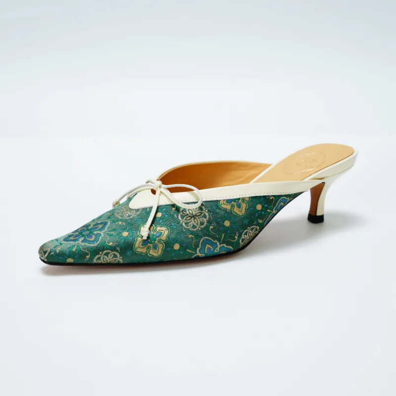 Side view of emerald green Shu Brocade kitten heel mule shoes with pointed toe and open back design.