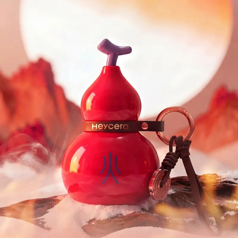 Red Fire element porcelain Hulu bag charm displayed in a warm red mountain-inspired setting with leather strap details.