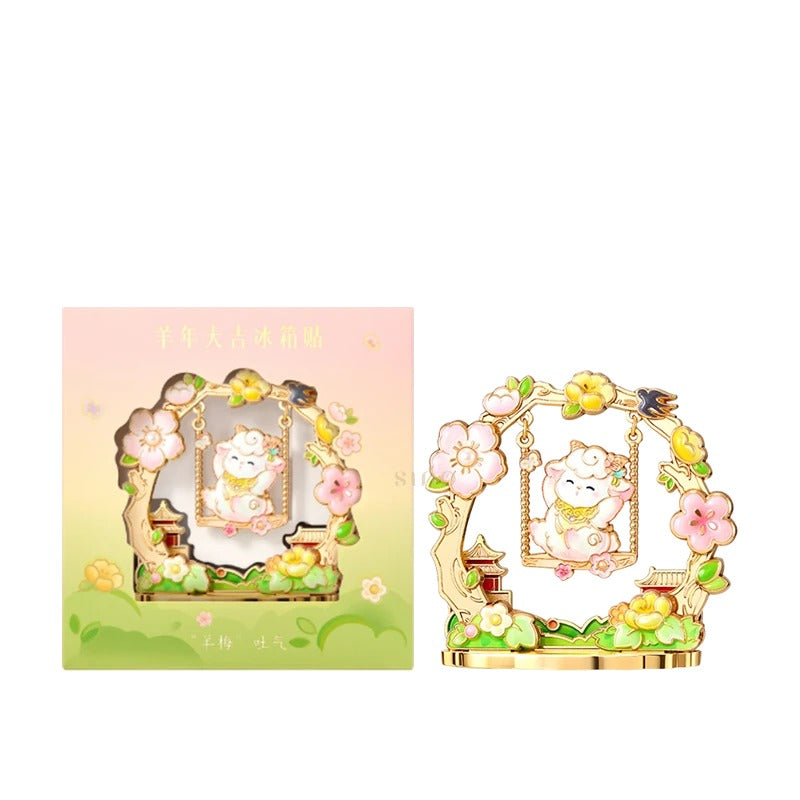 Floral Year of the Goat fridge magnet featuring a cute sheep on a swing, pink and yellow blossoms, and matching pastel green gift packaging.