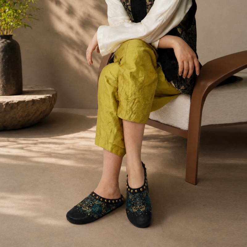 Pair of handcrafted Song Brocade mule shoes with elegant Chinese textile patterns.