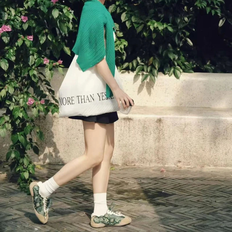 Women styling Jade Green Shu Brocade Persimmon Motif ballet sneakers with a relaxed summer outfit, blending heritage and contemporary fashion.