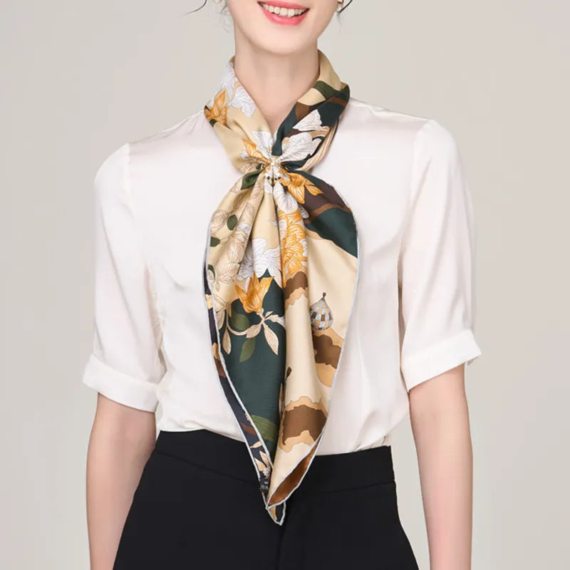 100% silk scarf with magnolia design knotted at neck.
