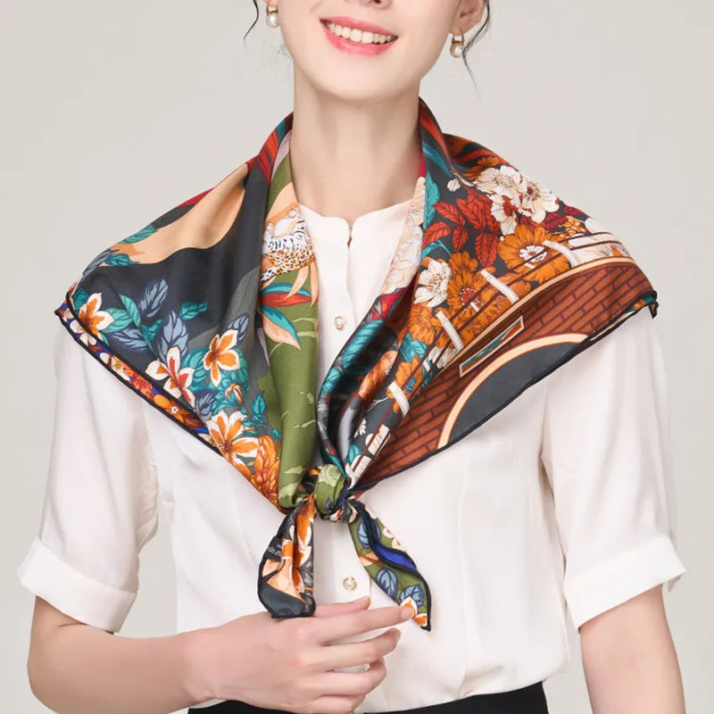 Light green silk scarf with Pipa & Hibiscus design knotted at neck.