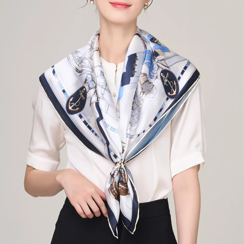 Nautical silk scarf knotted at chest on model.