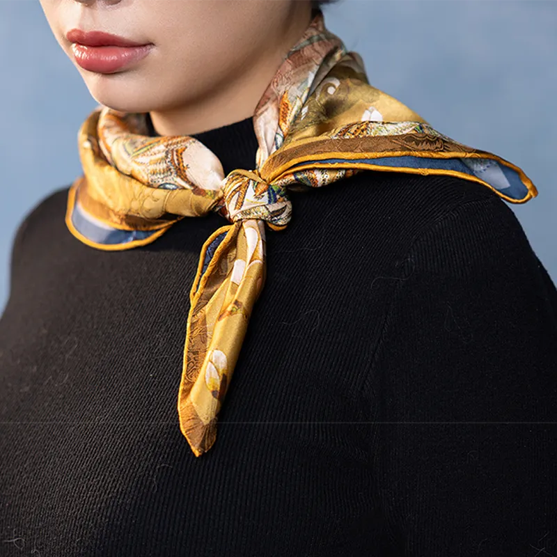 Model styling a Luxury Nanjing Brocade Bloom silk square scarf with a black top, showing elegant gold floral print.